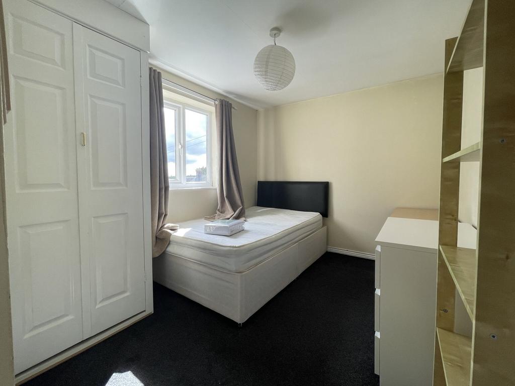 A bright and inviting double bedroom with ample...