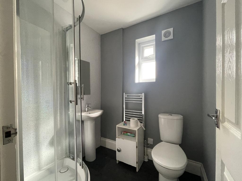 A modern and tidy bathroom featuring a shower, ...