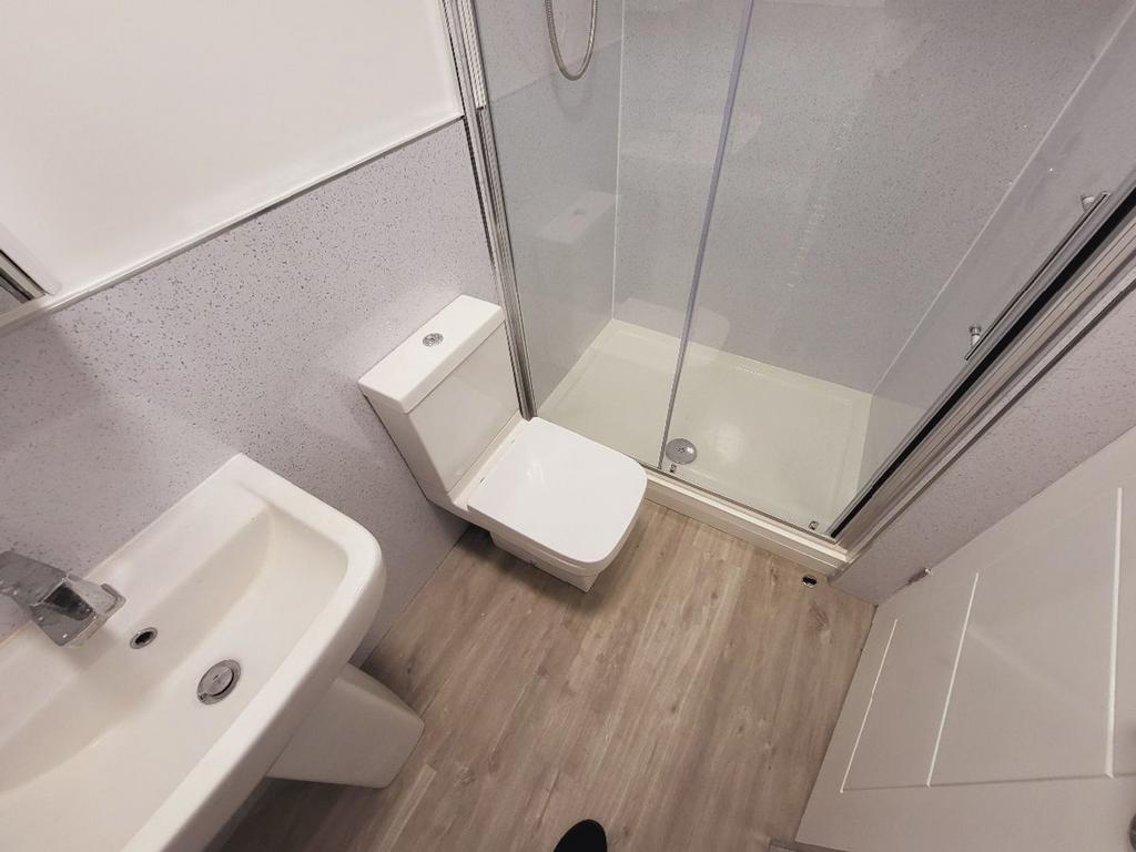 A modern bathroom featuring a sleek shower and ...