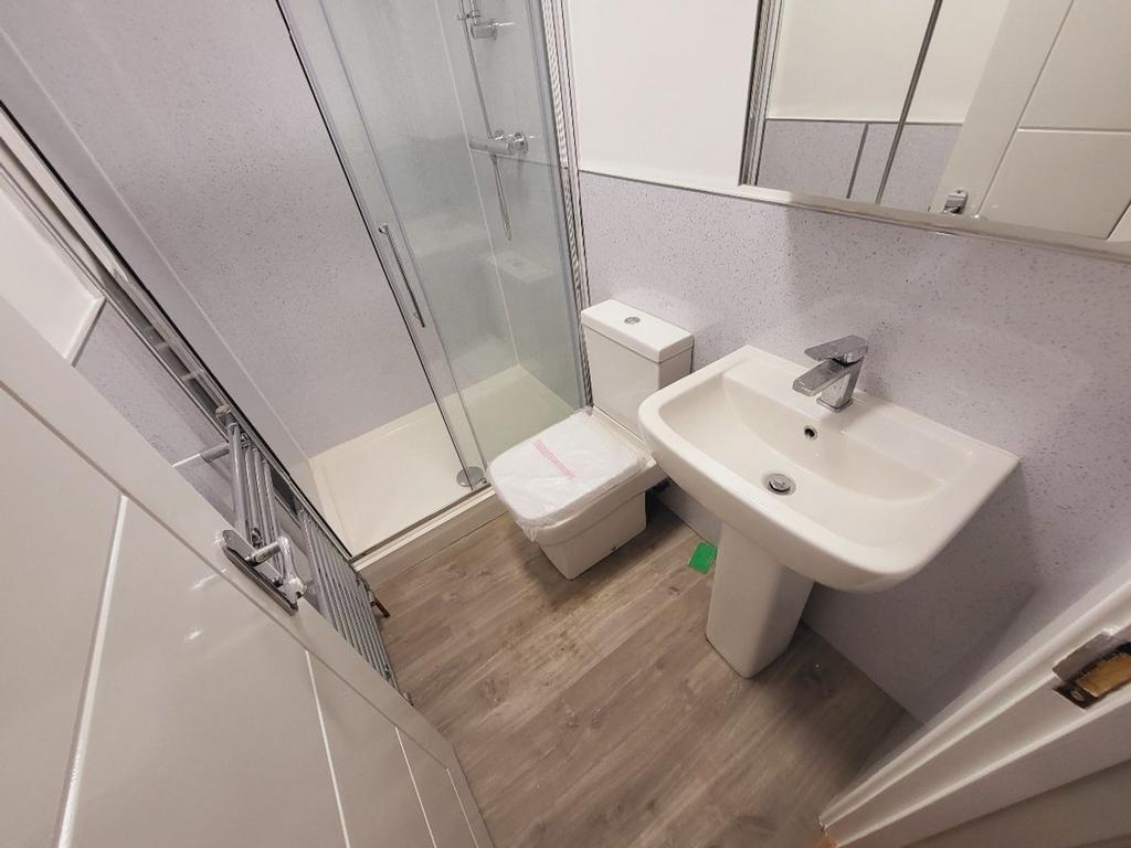 A modern bathroom featuring a sleek shower, con...