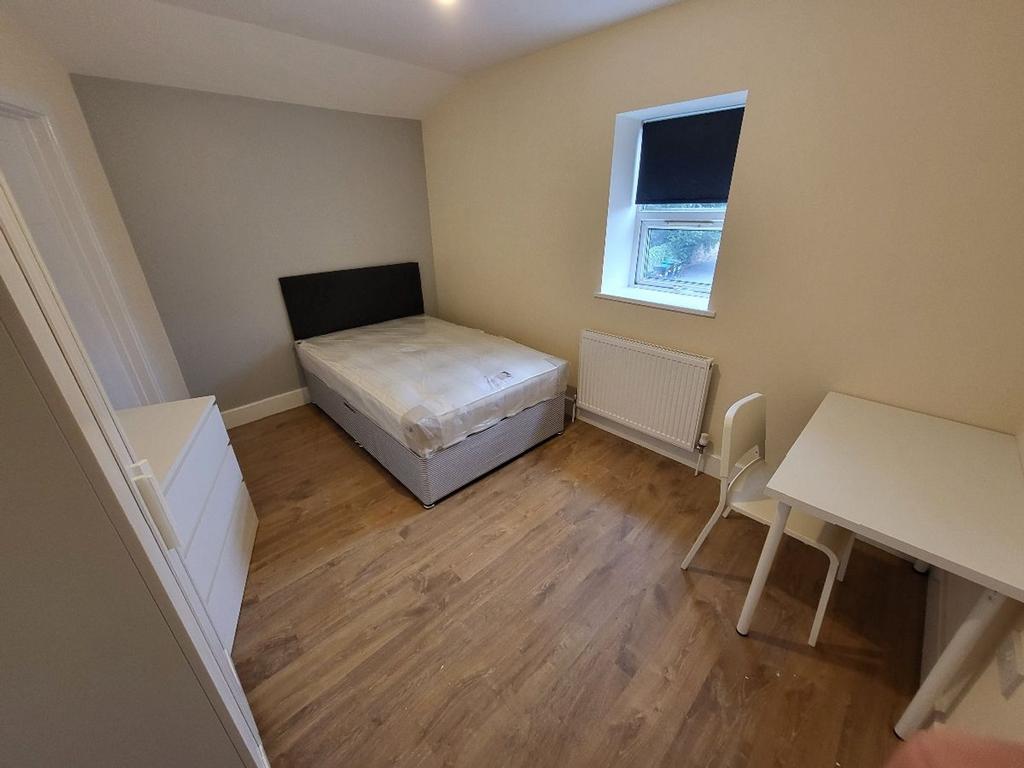 This inviting double bedroom features a comfort...