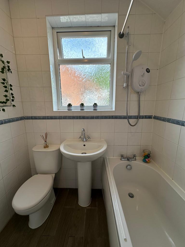 This well-maintained bathroom features a bathtu...