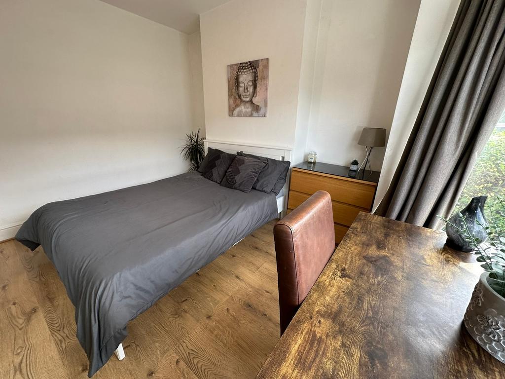 This stylish double bedroom features a comforta...