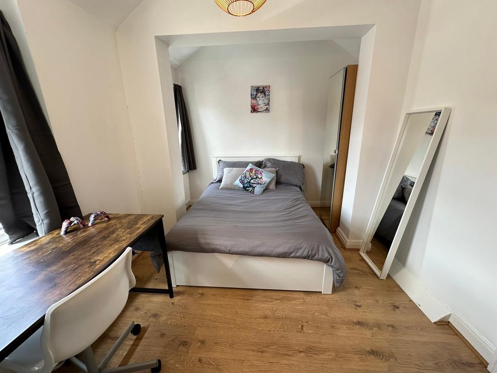 Cozy double bedroom featuring ample natural lig...