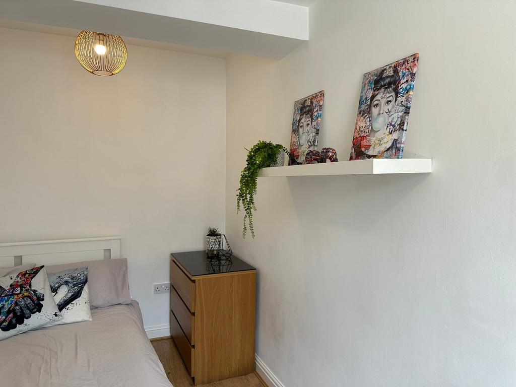 This cozy double bedroom features stylish decor...