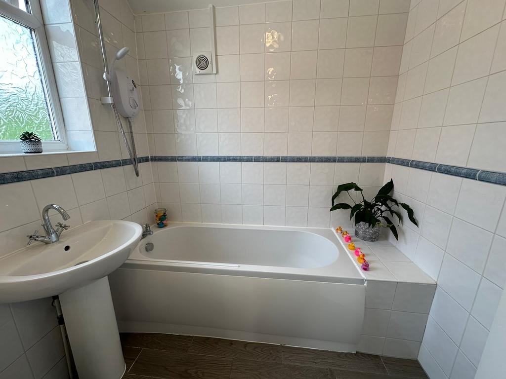 A bright and modern bathroom featuring a spacio...