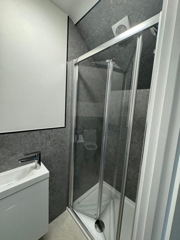 Modern bathroom featuring a sleek shower and st...