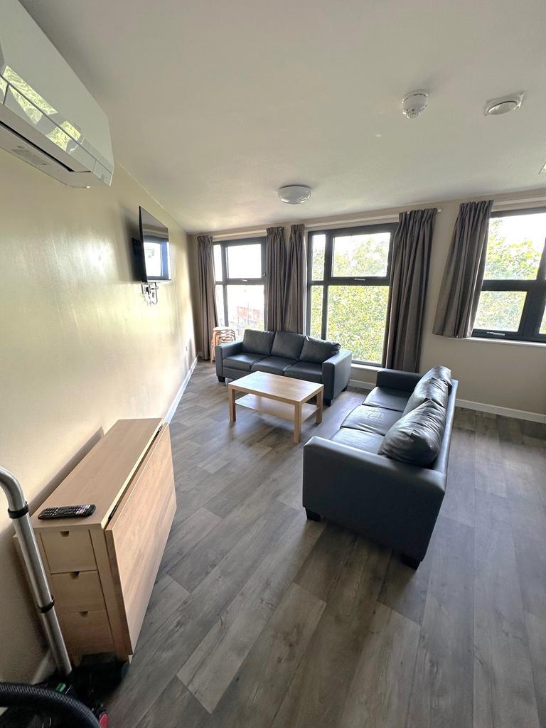 A bright and spacious living room featuring lar...