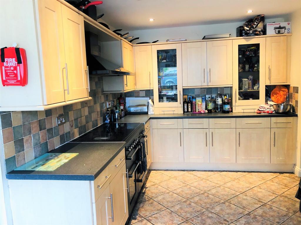 Modern kitchen featuring ample storage and work...