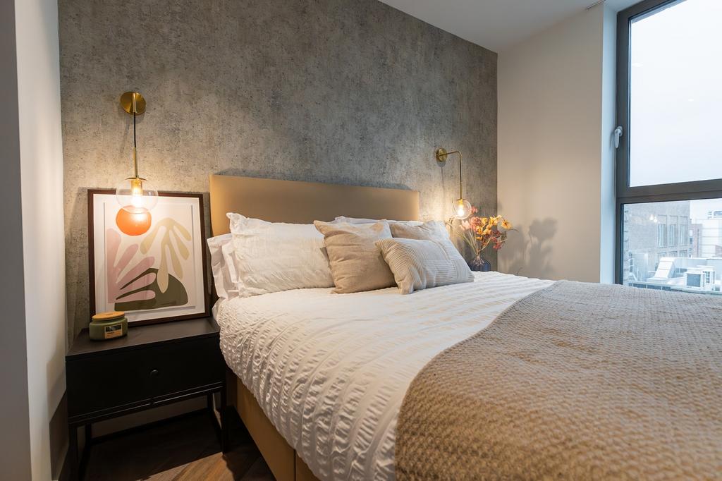 A stylish and well-lit double bedroom featuring...