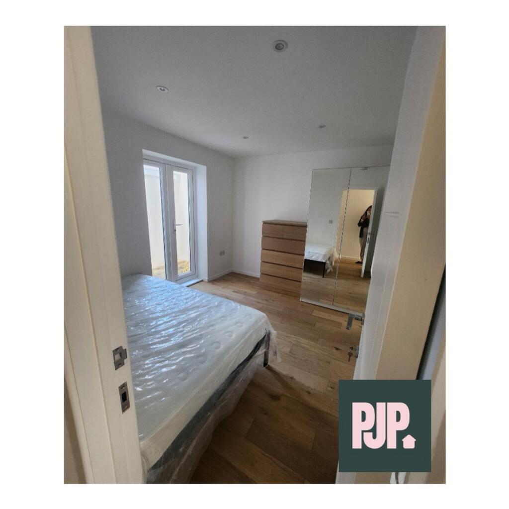 This spacious double bedroom features ample nat...
