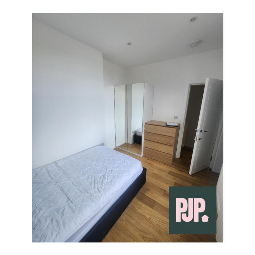 A bright and spacious double bedroom featuring ...