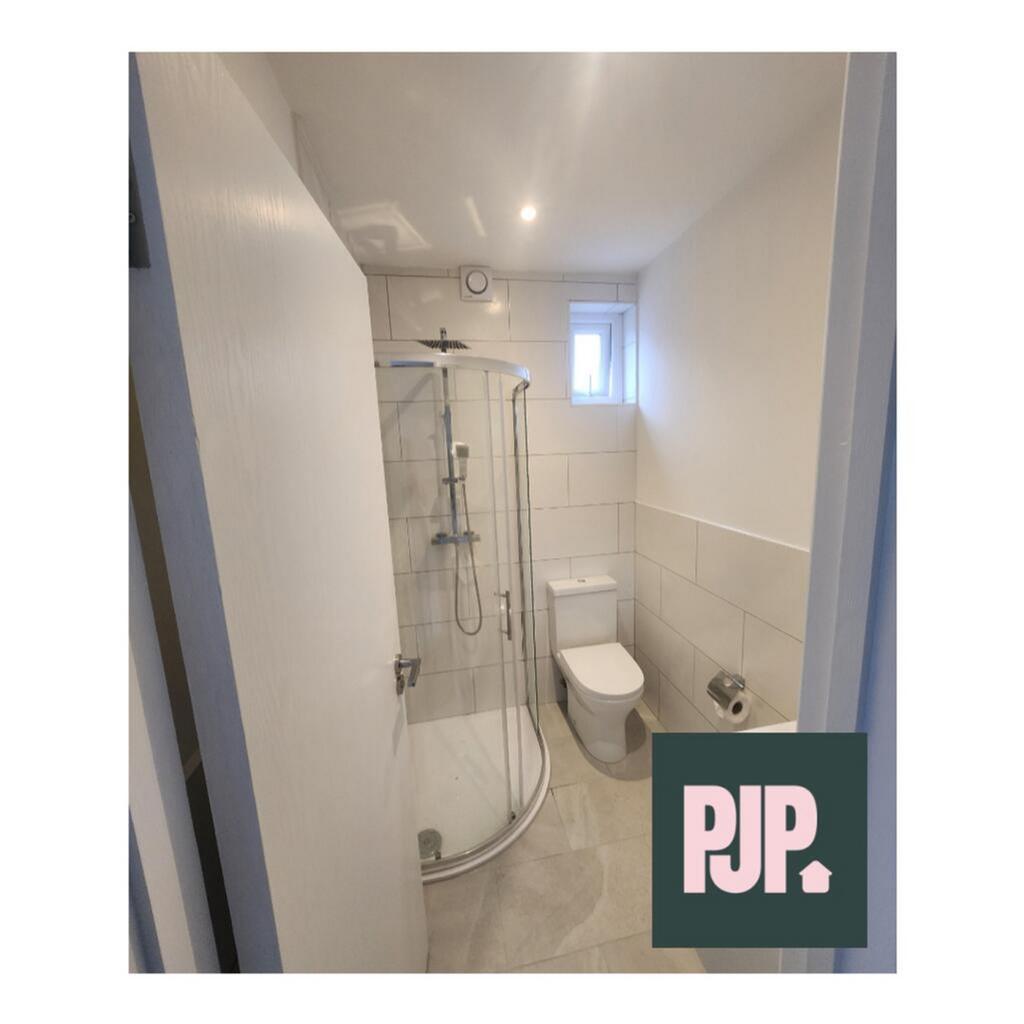 Modern bathroom featuring a sleek shower unit a...