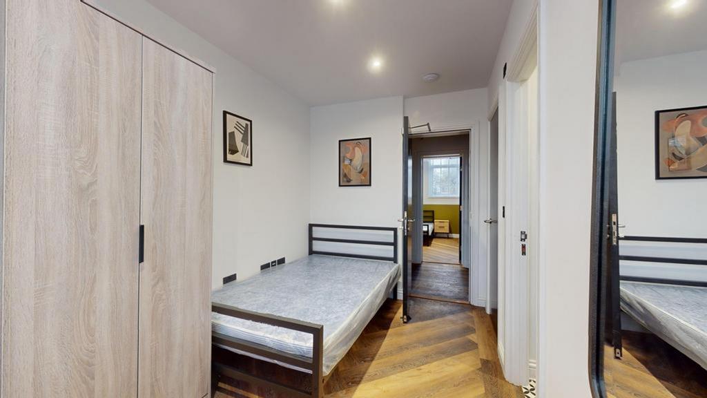 A spacious and modern double bedroom with styli...