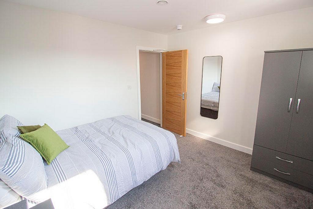 This inviting double bedroom features a cozy la...