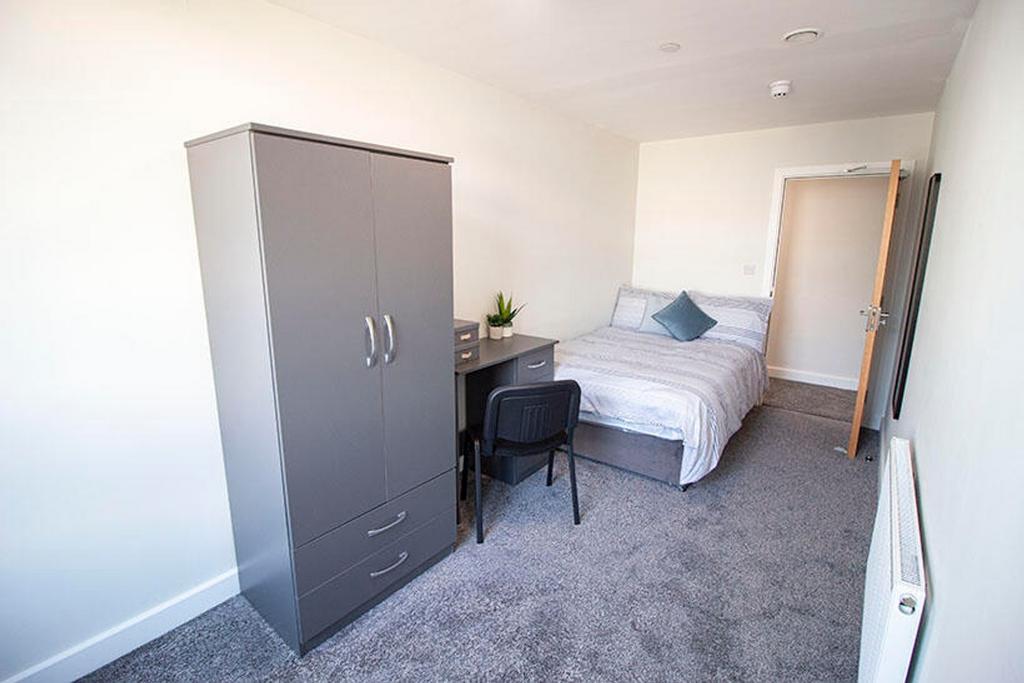This spacious double bedroom features a comfort...