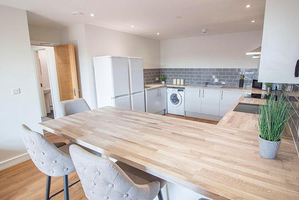 This modern kitchen features a spacious layout ...