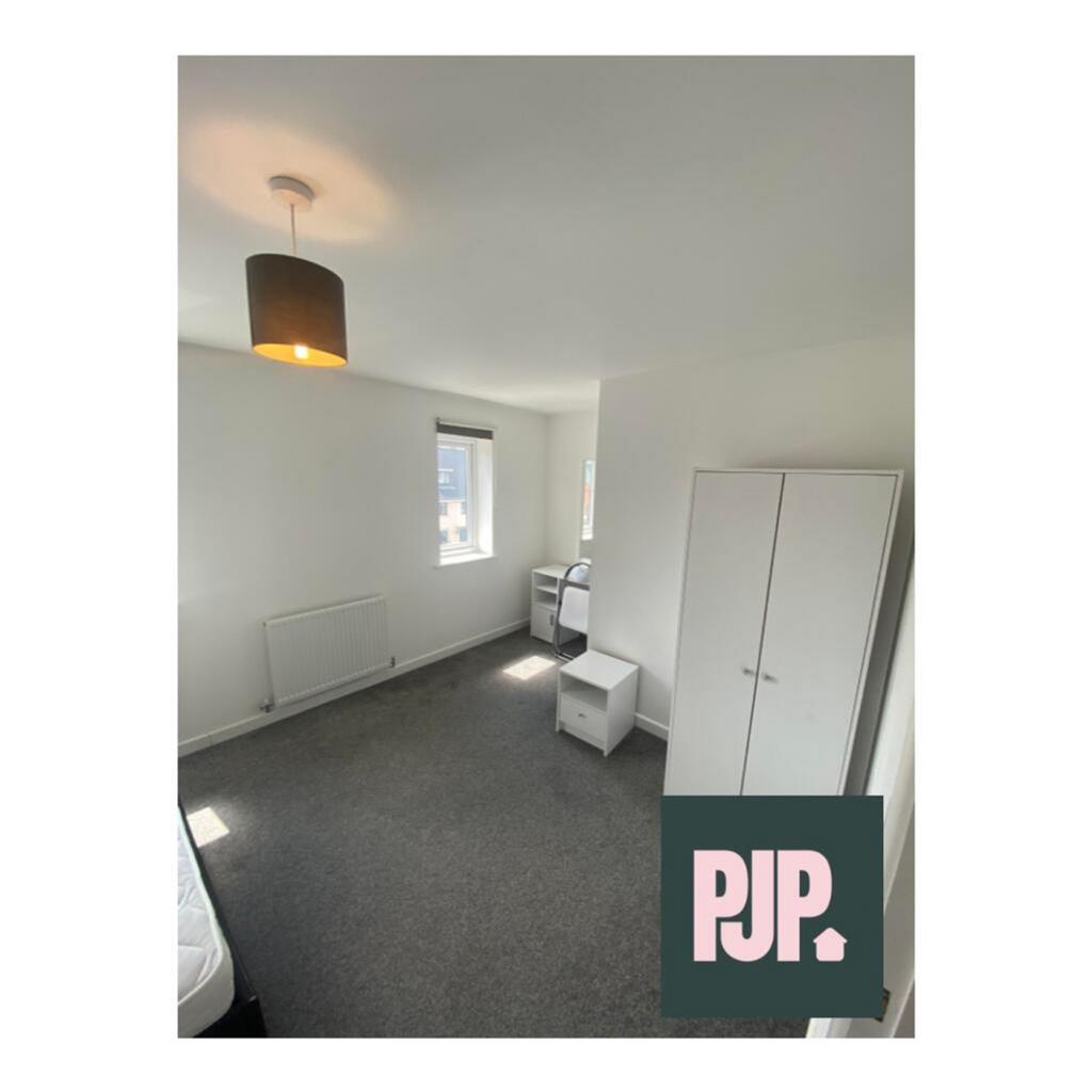 Spacious double bedroom featuring bright natura...