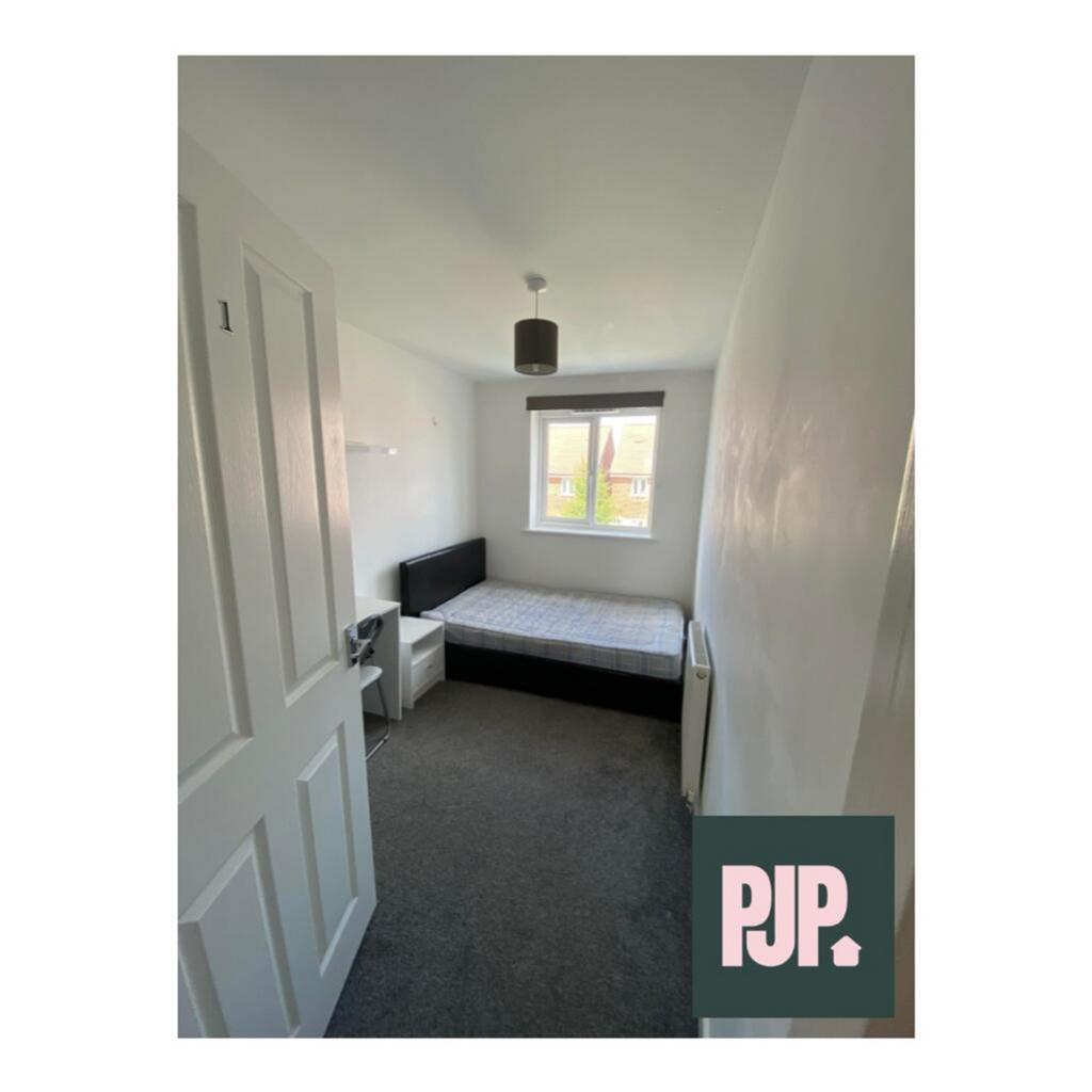 This inviting double bedroom features a comfort...