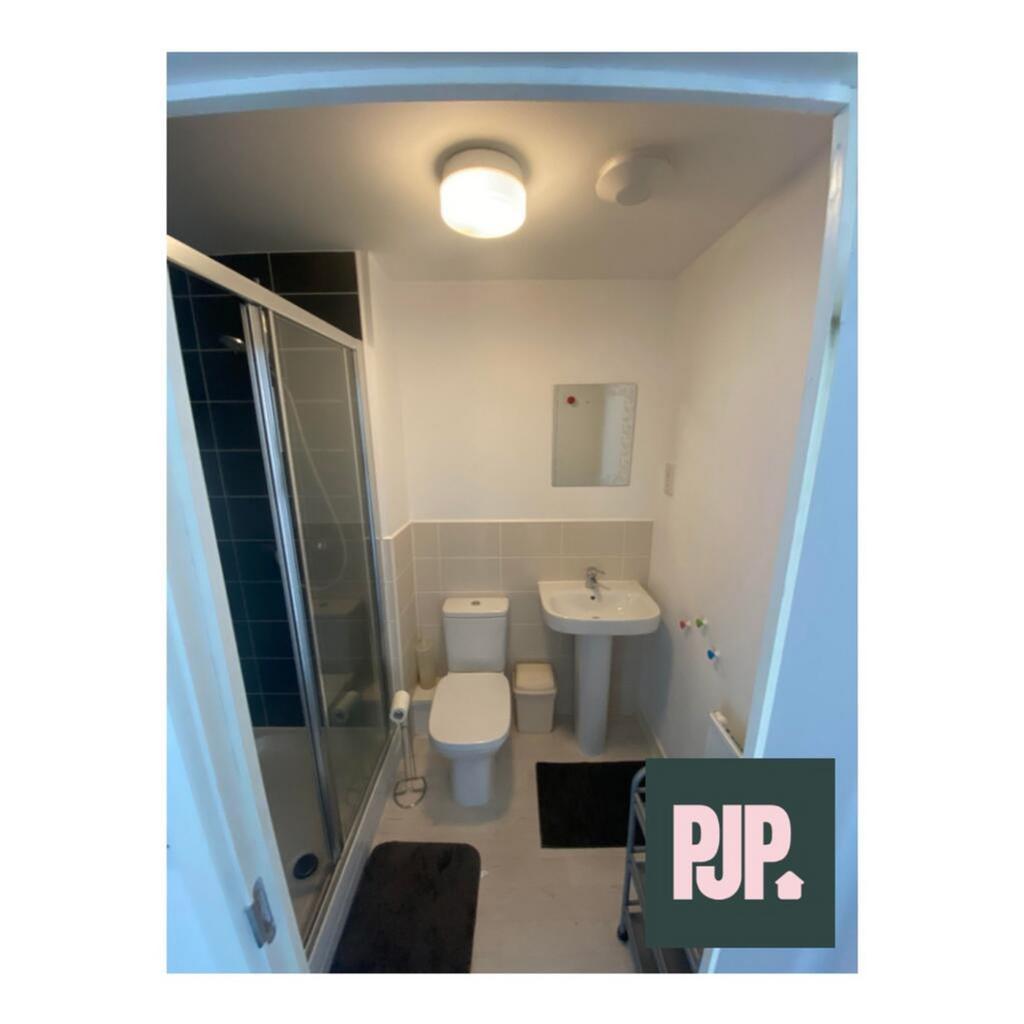 Modern bathroom featuring a spacious shower, sl...