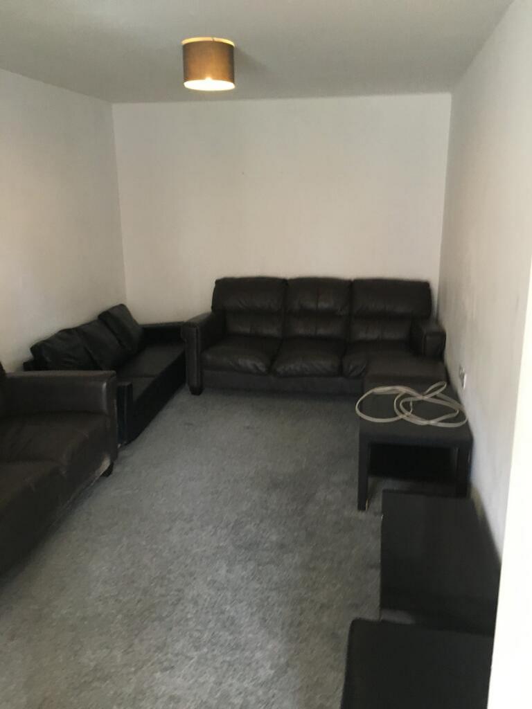 Spacious living room featuring comfortable leat...