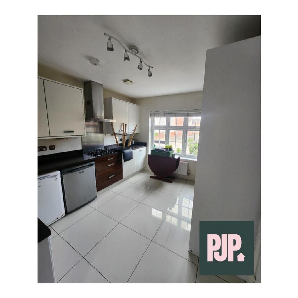 Spacious and modern kitchen featuring sleek cab...