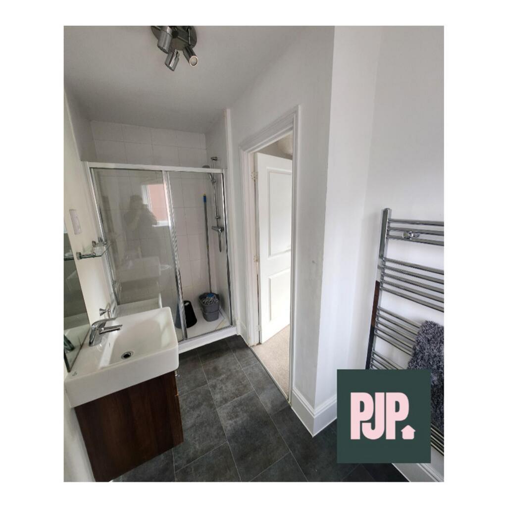 Modern bathroom featuring a spacious walk-in sh...