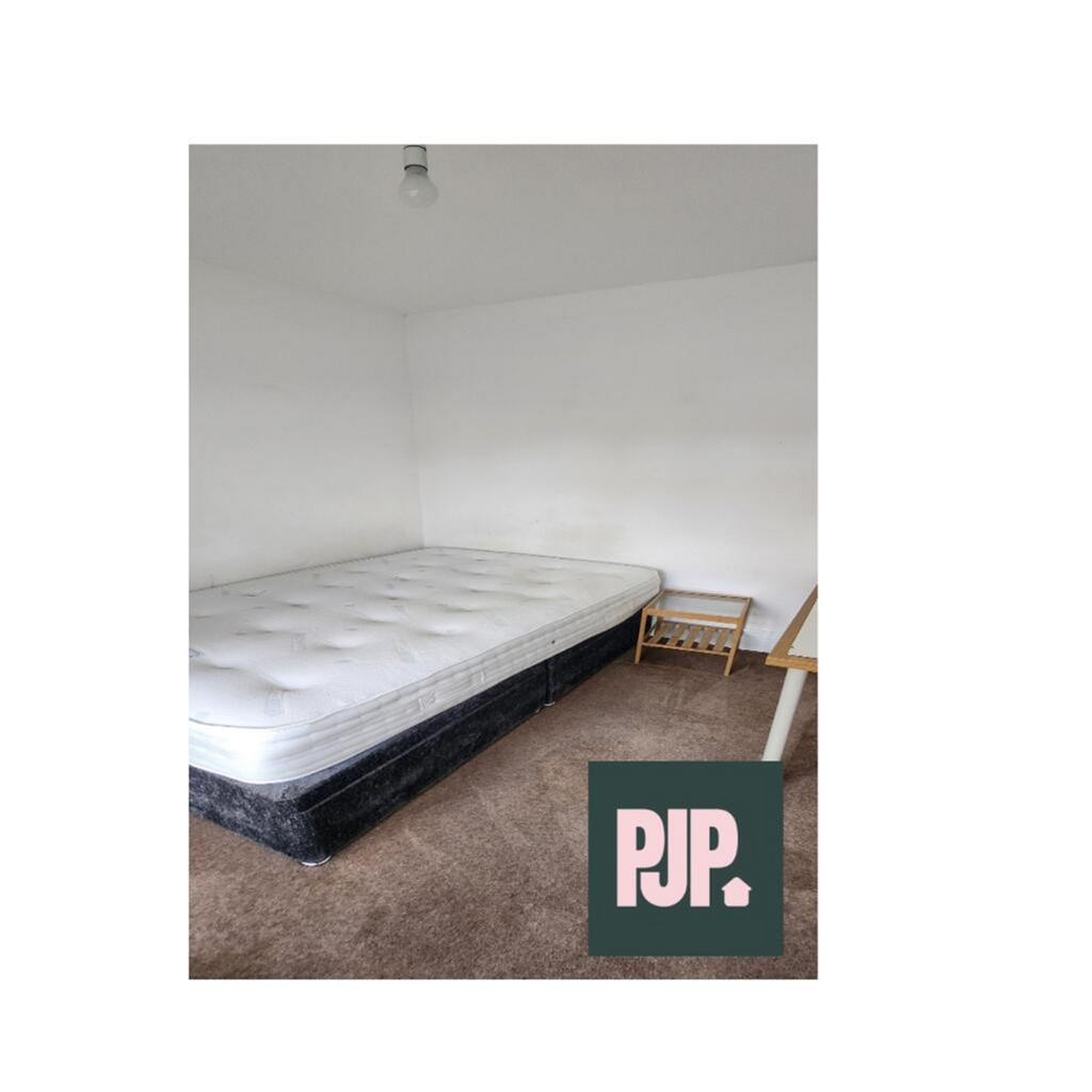 Spacious double bedroom featuring a comfortable...
