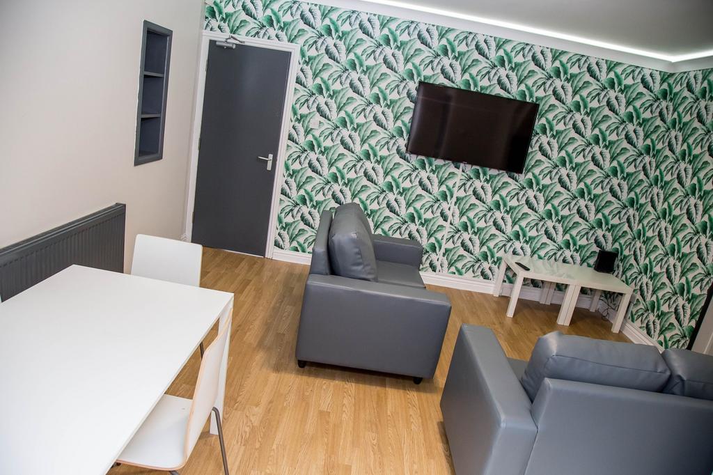 A stylish communal lounge featuring modern furn...