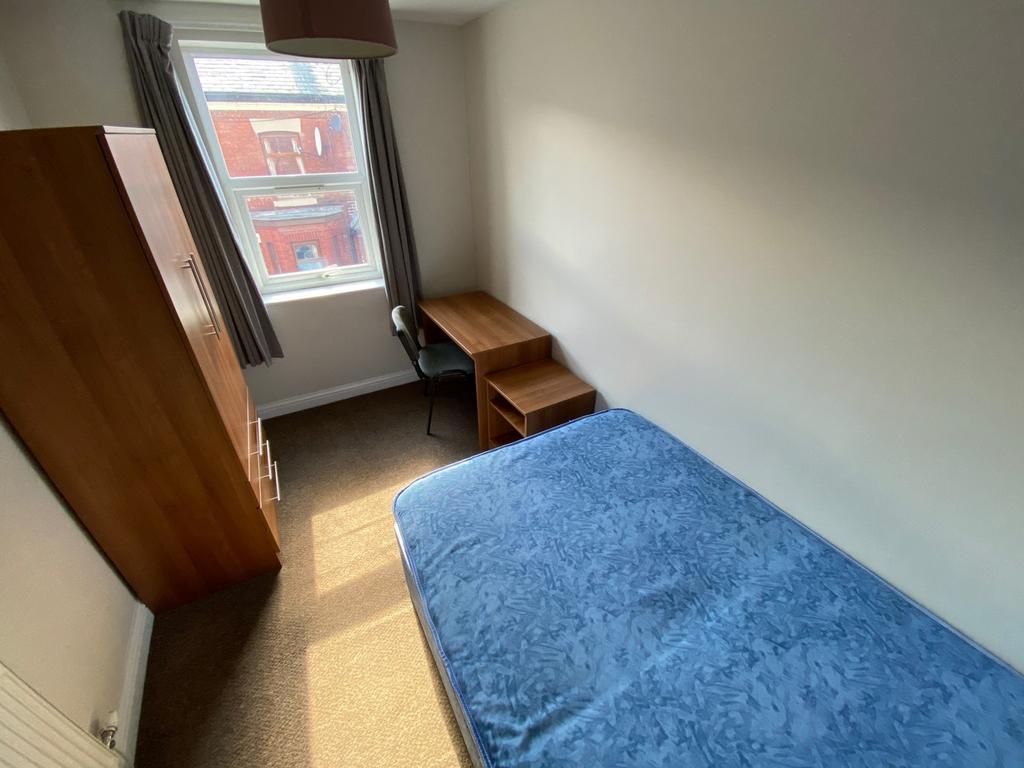 A cozy double bedroom featuring a comfortable b...