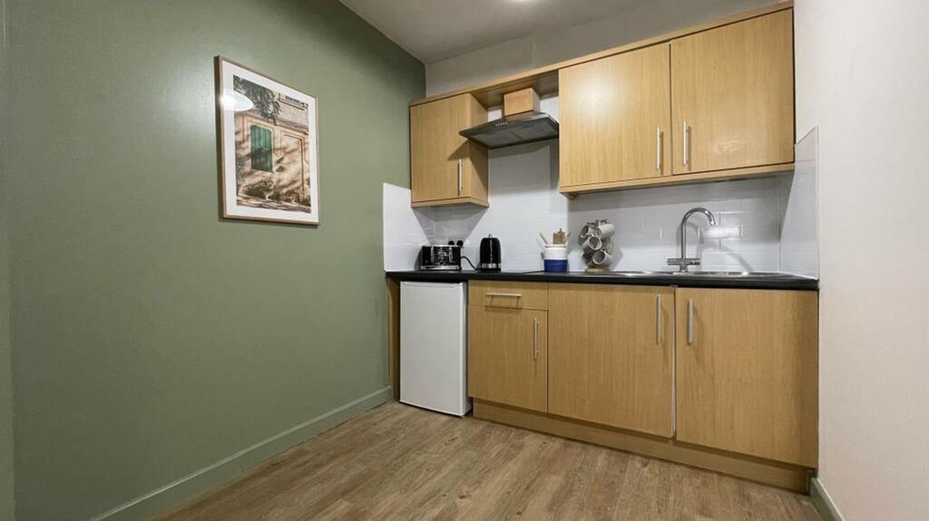 A modern kitchenette with sleek cabinetry and a...