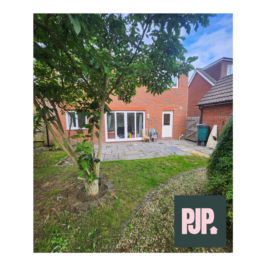 A spacious and well-maintained garden area, per...