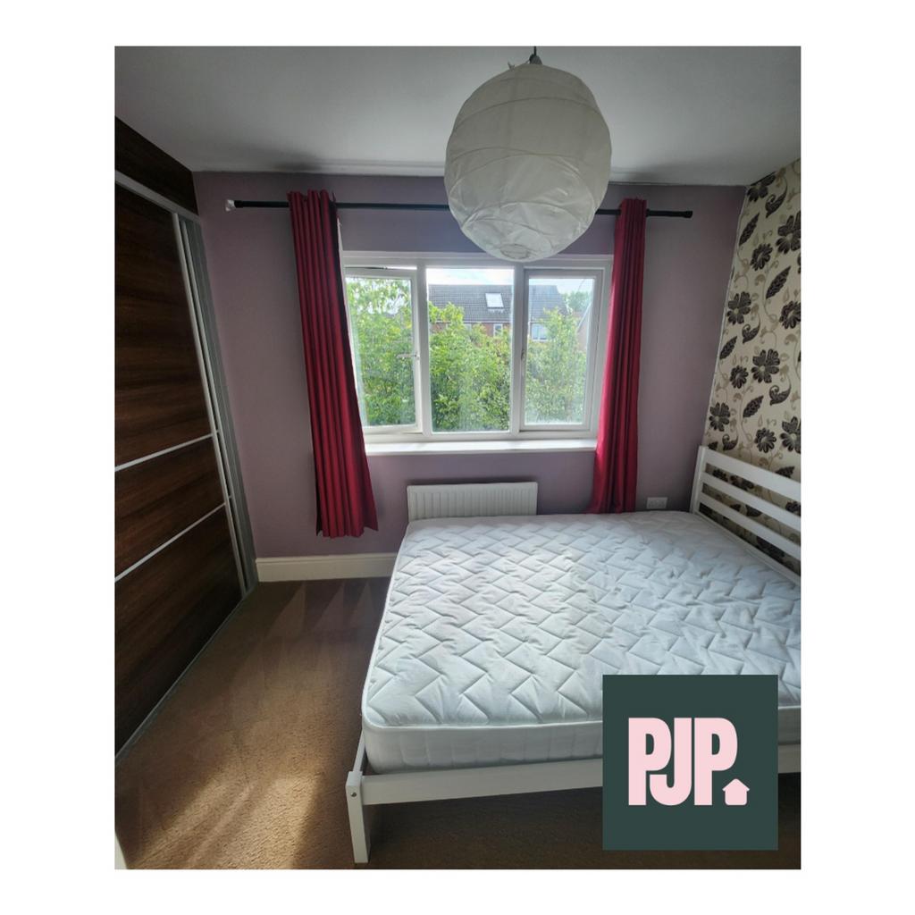 A bright and inviting double bedroom with a spa...