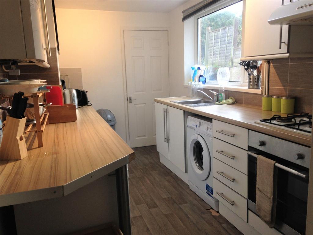Bright and modern kitchen featuring ample count...