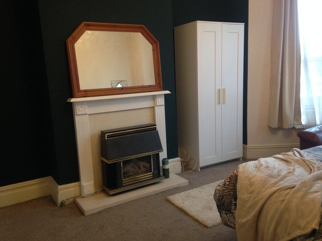 This inviting double bedroom features a cozy at...