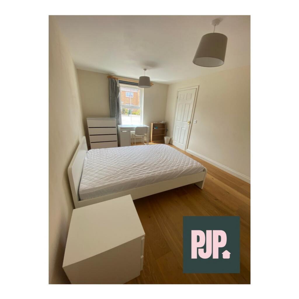 Spacious double bedroom featuring ample natural...