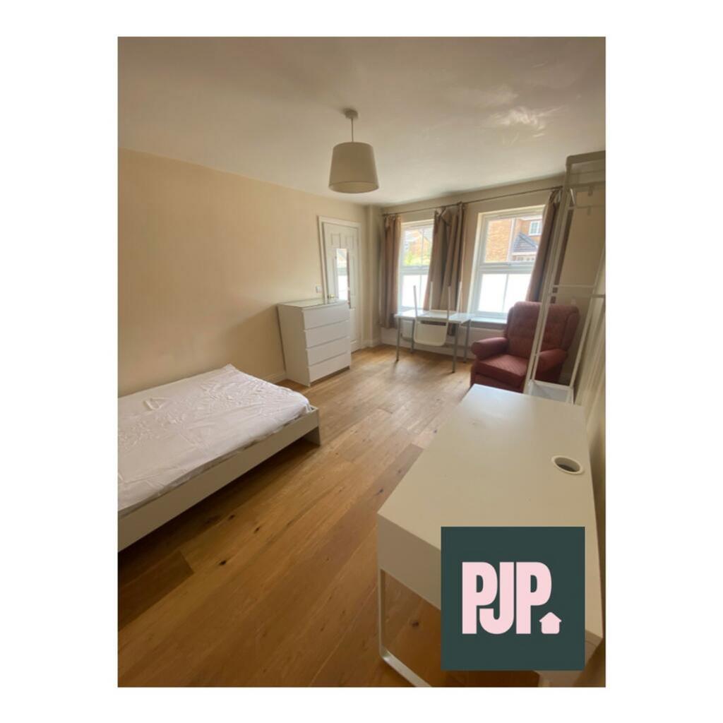 A bright and spacious double bedroom featuring ...