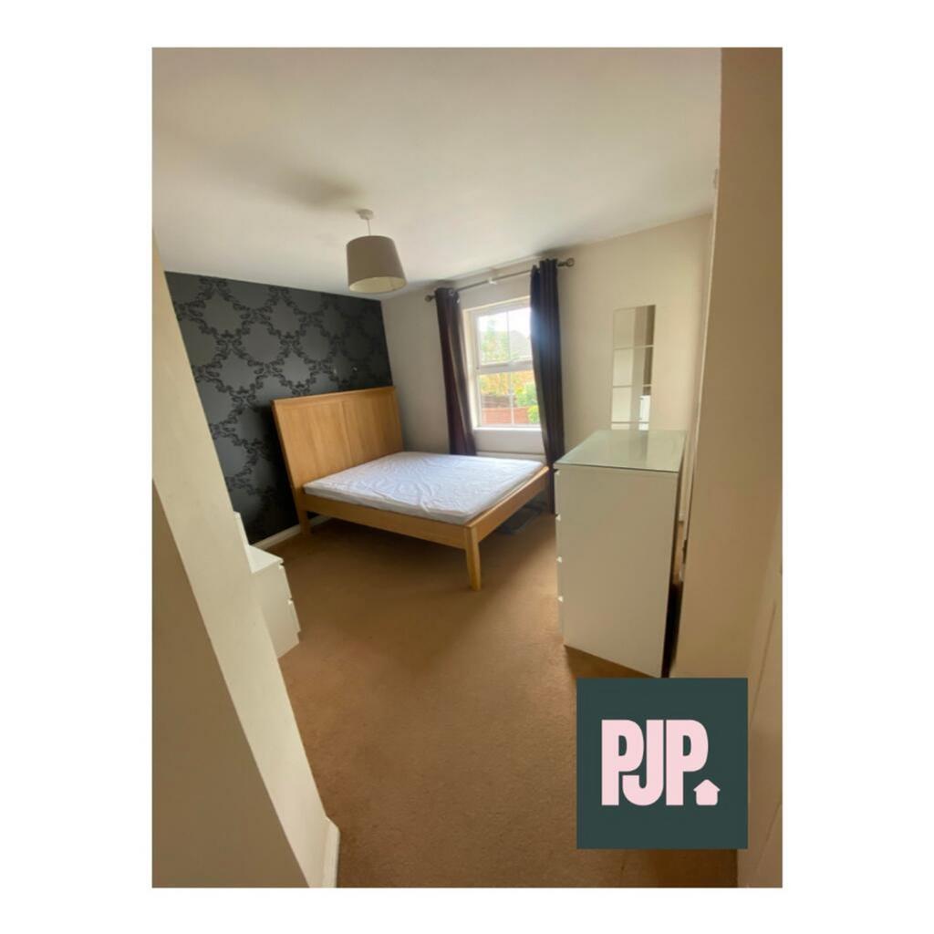Bright and spacious double bedroom featuring a ...