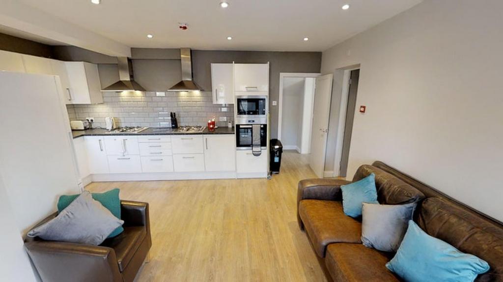 Spacious and modern kitchen with sleek cabinetr...
