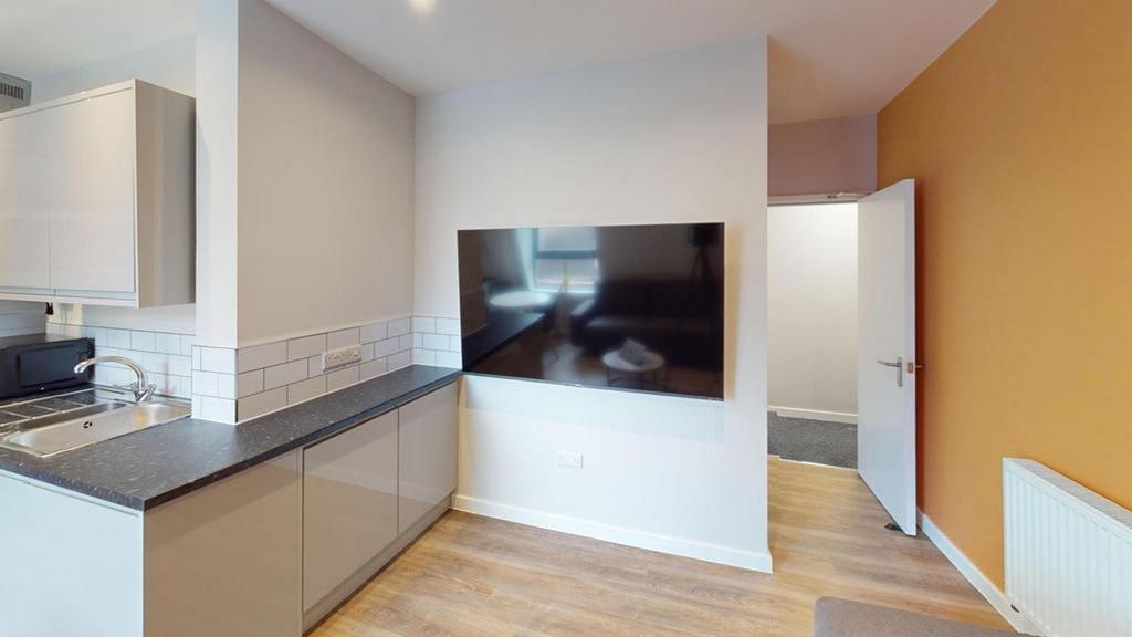 A modern kitchenette that is clean and well-lit...