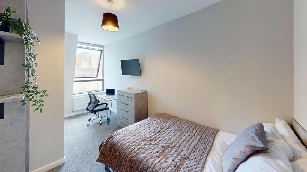 A spacious and well-lit double bedroom featurin...