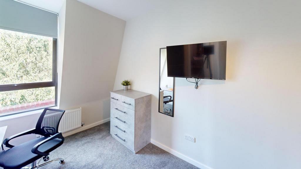 A bright and modern double bedroom featuring a ...