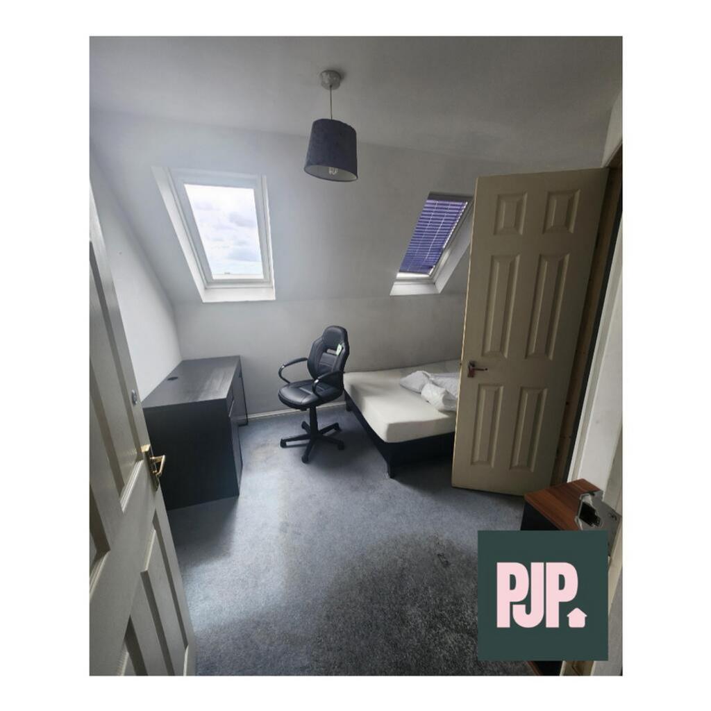 Cozy double bedroom featuring a comfortable bed...