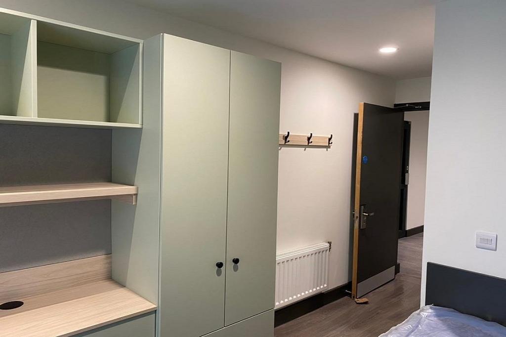 A modern double bedroom featuring stylish stora...