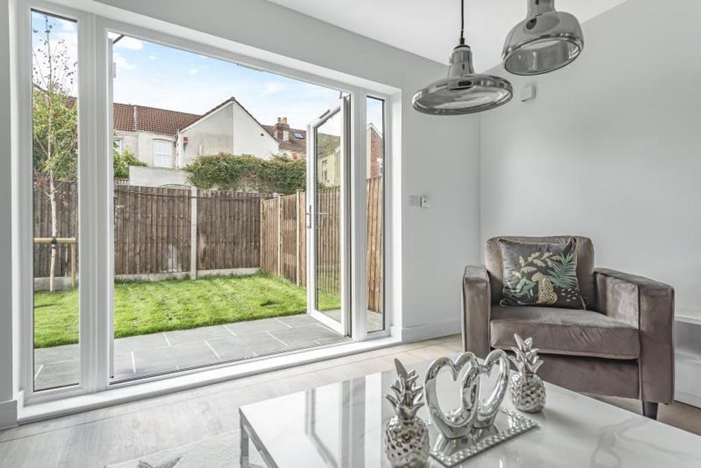 A bright and inviting living room featuring lar...