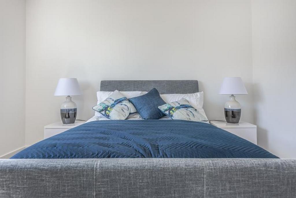 This stylish double bedroom features a cozy des...