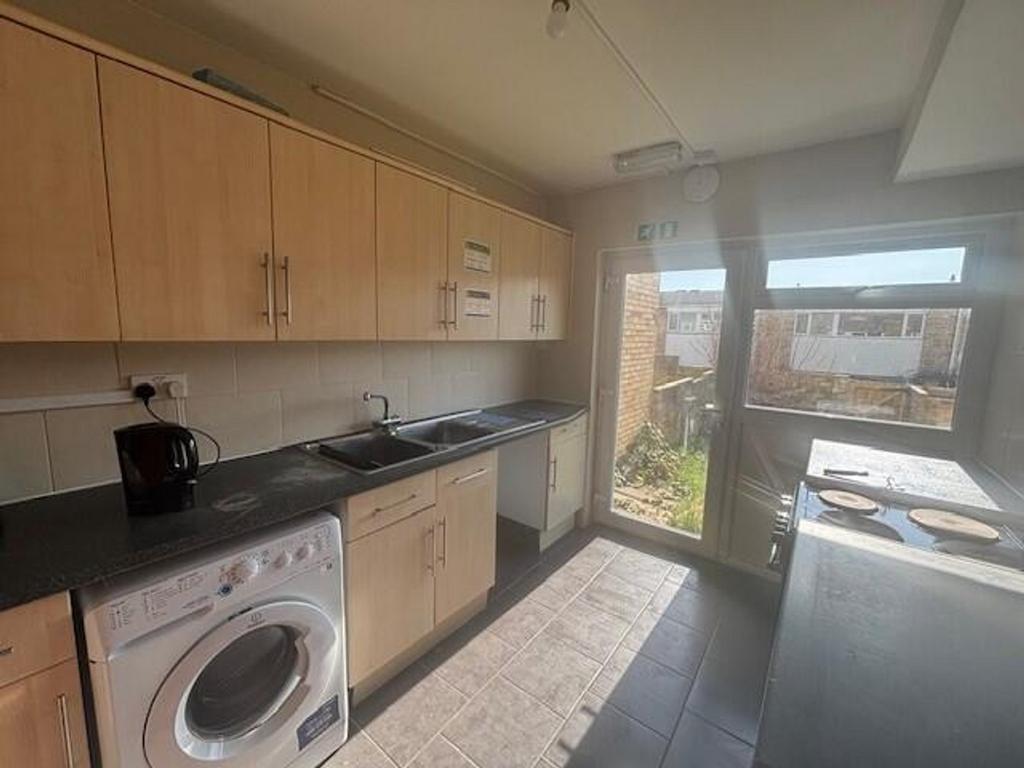 Bright and modern kitchen featuring ample cabin...