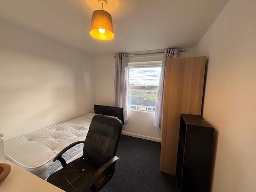 This inviting double bedroom features a large w...