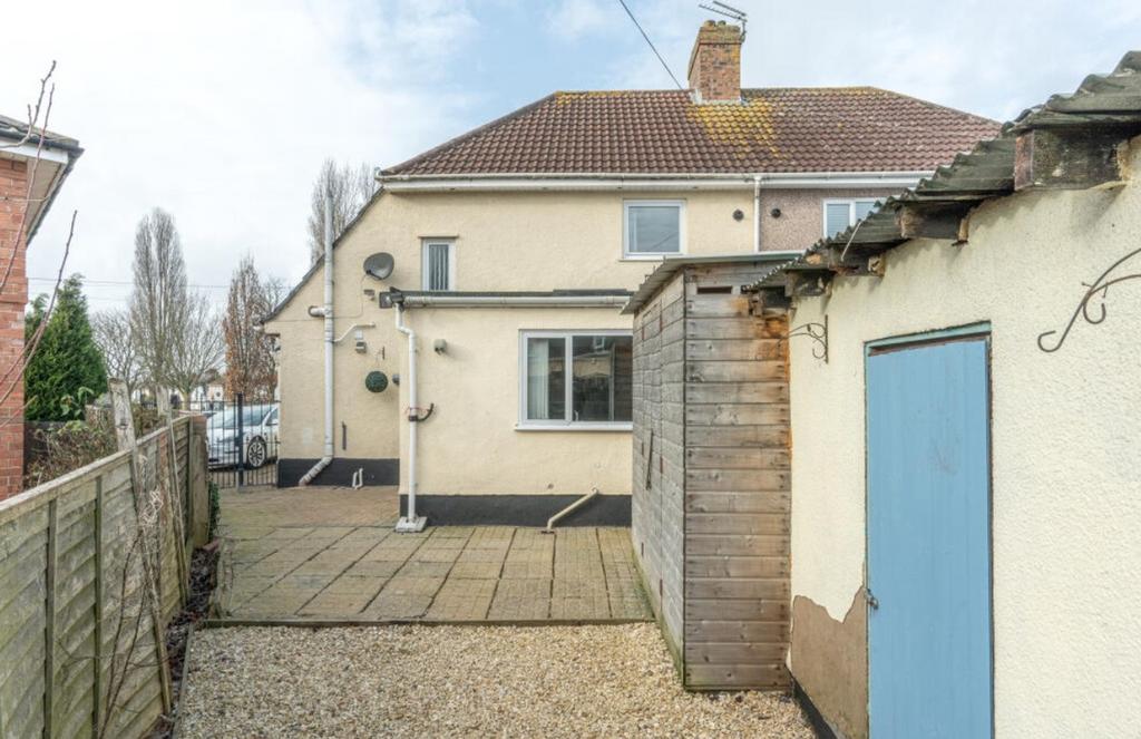 A charming exterior view of the property featur...