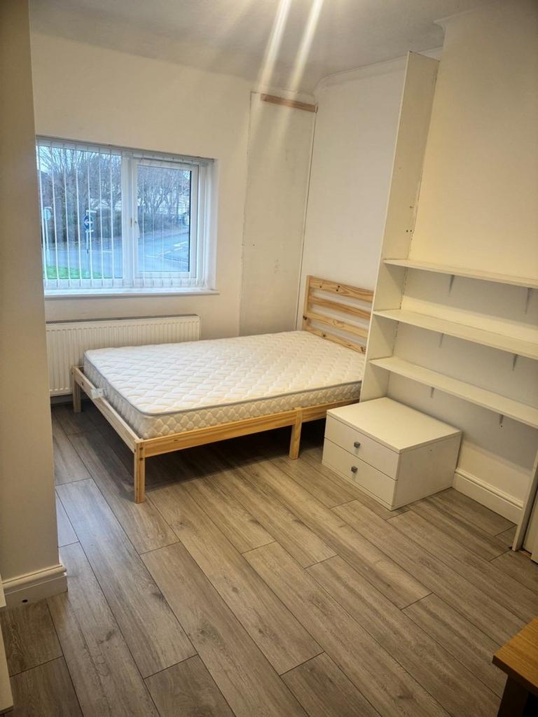 A bright and tidy double bedroom featuring a sp...